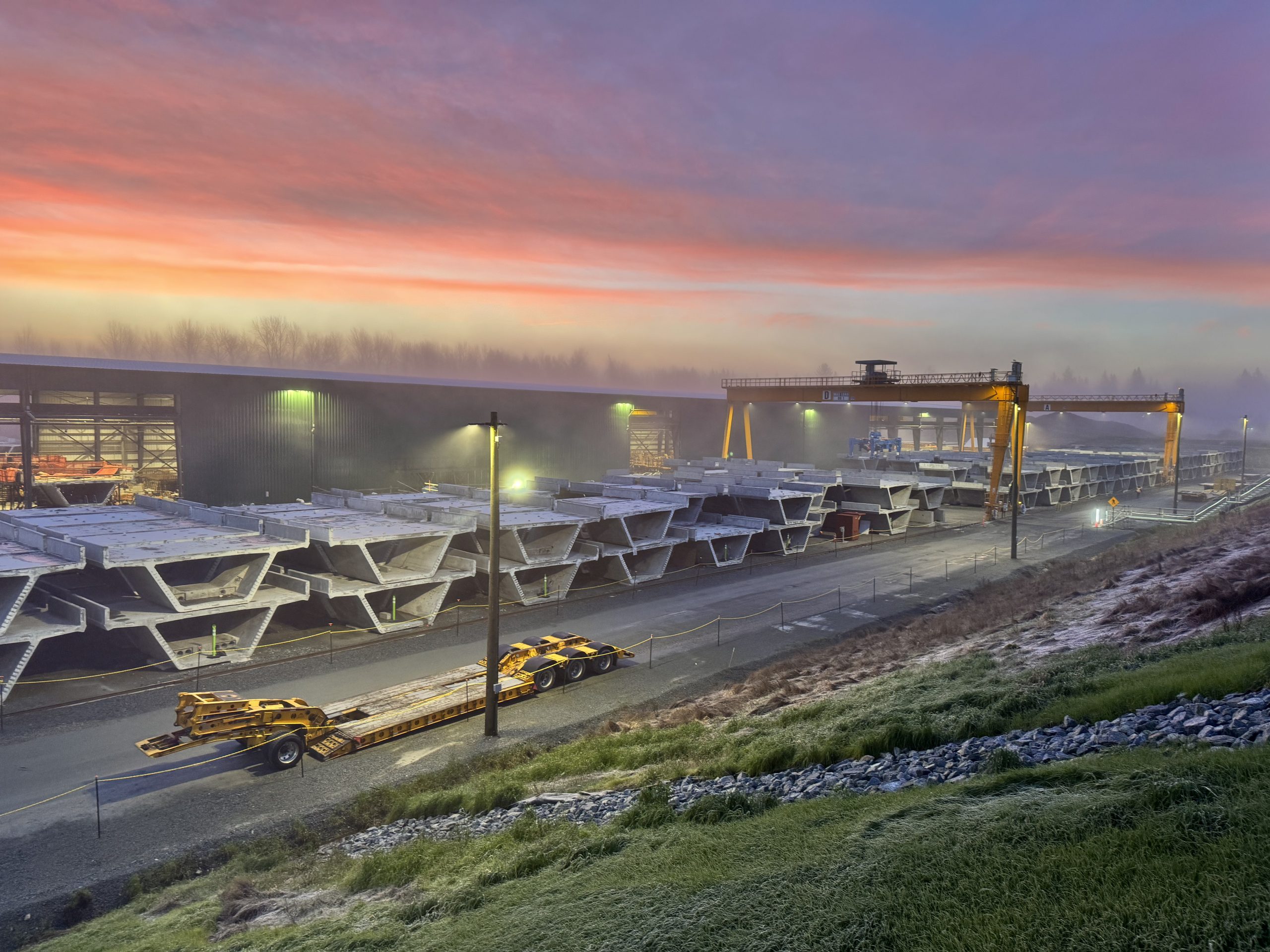 Sunrise over the precast concrete facility where guideway segments are produced and stored.